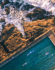 a view of mountains and sea with waves