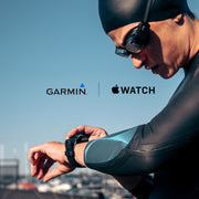 Swimmer checking their watch showing swum, pace, stroke rate data and more in open water swimming.